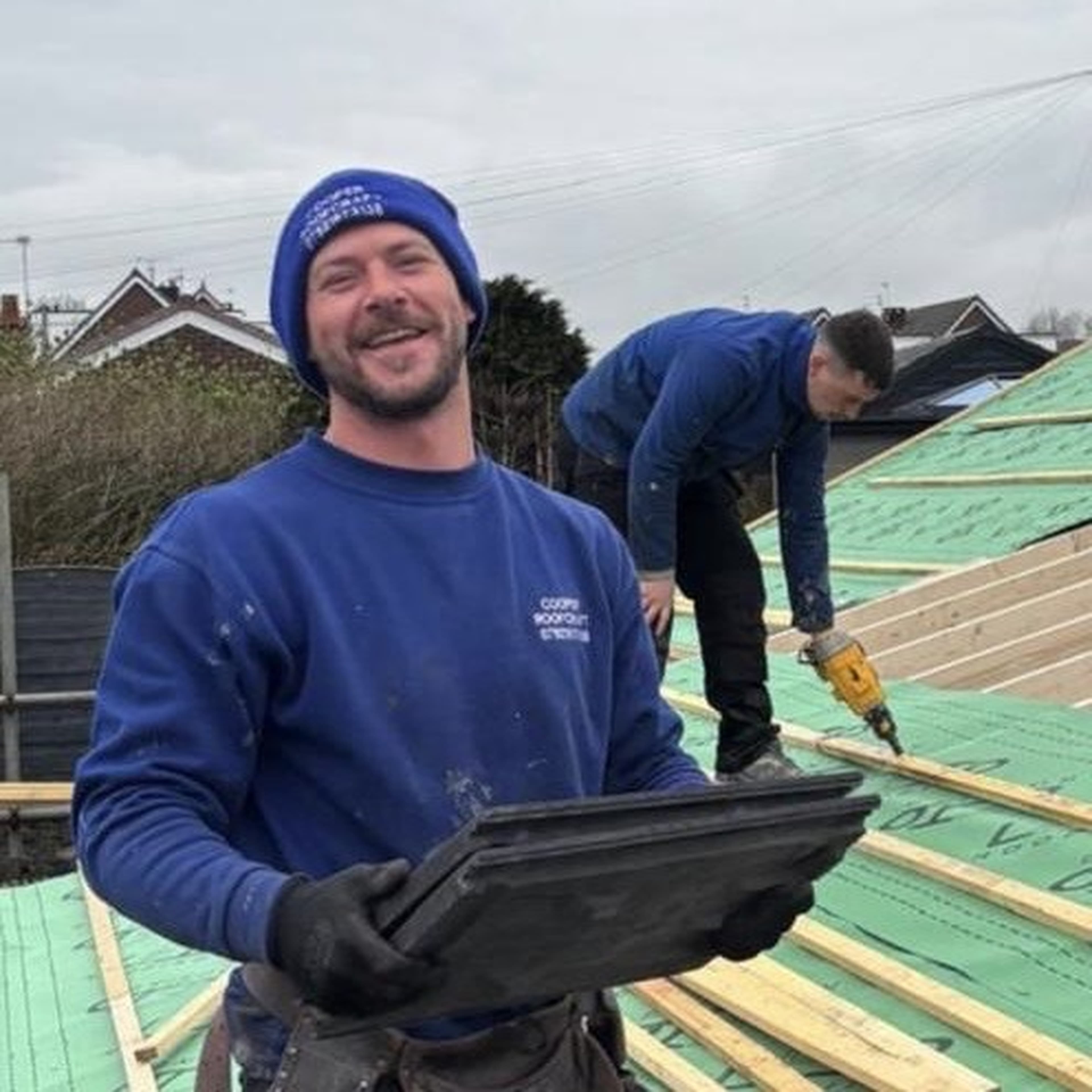 Danny Cooper and team member working on a roof installation