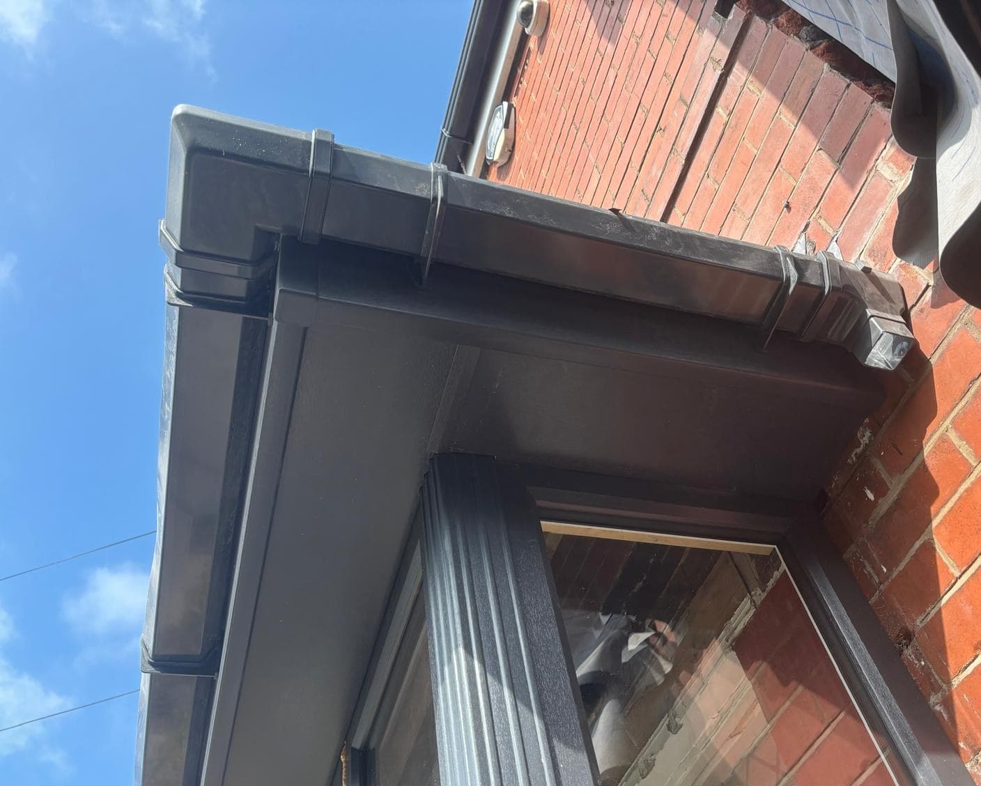 Black uPVC fascia soffit and gutter installation domestic roofline Cooper Roofcraft