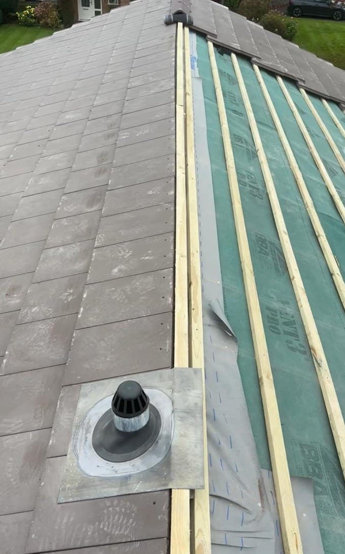 Roofing underlay battens and tile installation in progress domestic re-roof Manchester