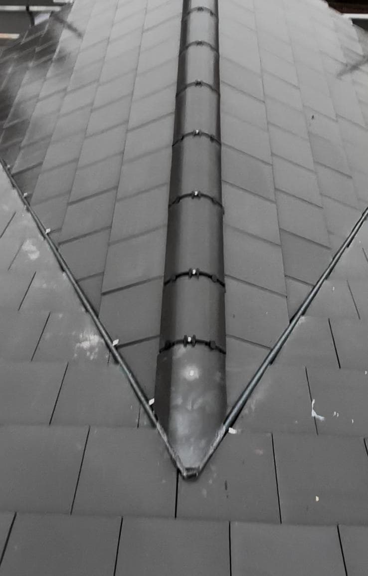 Dry ridge system and dark grey roof tiles fitted by Cooper Roofcraft Greater Manchester